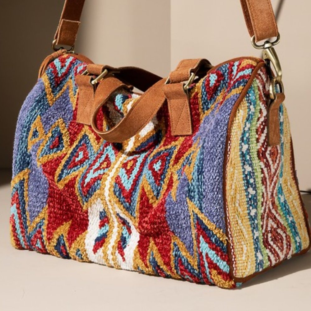 Beautiful woven Winthrop Boston Bagwith genuine suede handle and tassel detail.